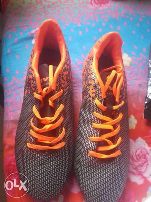 Pair Of Orange And Black Low Top Shoes