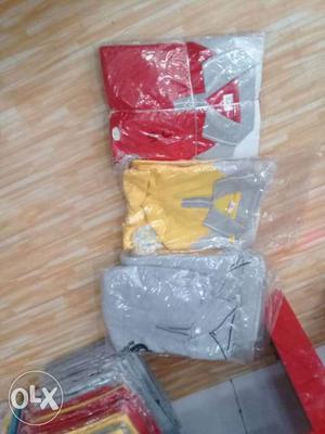 Three Gray, Yellow, And Red Polo Shirts