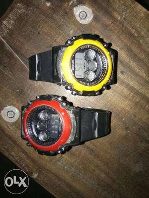 Two Round Black, Red, And Yellow Digital Watch With Bands