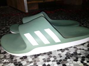 Pair Of Green And White Adidas Slides