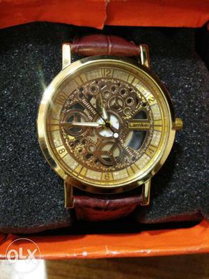 Round Gold Mechanical Watch With Brown Leather Bracelet