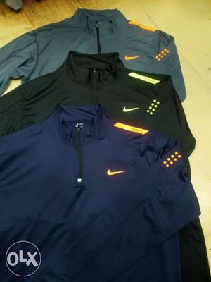 Three Gray, Black, And Blue Nike Jackets