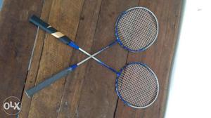 Two Blue And Gray Badminton Rackets