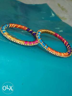 Two Teal, Pink, And Purple Silk Thread Bangles