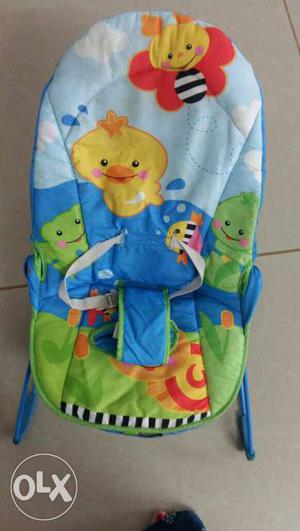 Baby's Blue, Green, And Yellow Animal Themed Bouncer