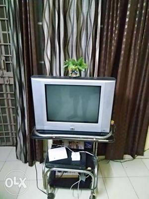Grey And Black Widescreen TV With Stainless Steel Stand