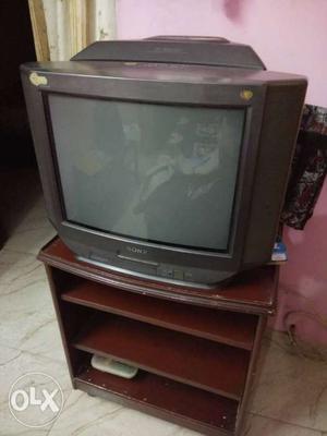 Sony 21 inch TV with a sub-woofer on top..