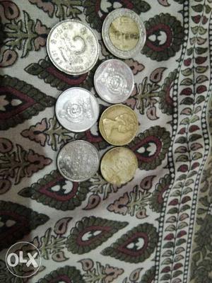 Seven Several Silver-colored And Gold-colored Coins