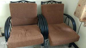 Two Black Wood-framed Brown Pad Armchairs