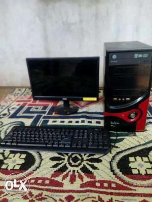 Black Flat Screen Computer Monitor With Tower And Keyboard