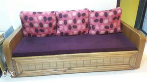 Brown And Purple Suede Couch With Three Throw Pillows