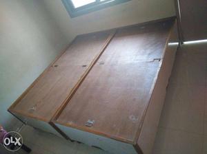 Two Brown Wooden Bed Frames