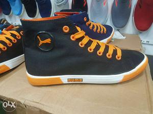 Pair Of Black-and-orange Puma Sneakers