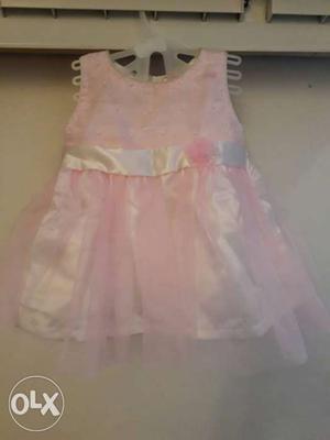 Soft baby pink gathered net infant frock with a
