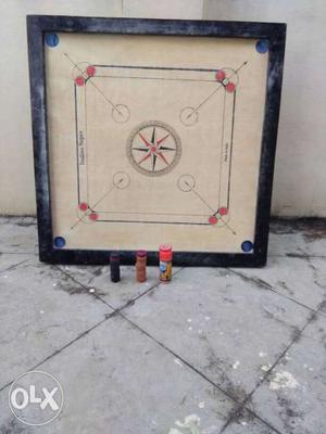 Carrom board with coins.