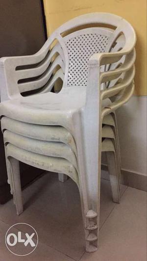 Four White Monobloc Armchairs