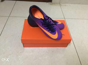 Pair Of Orange-and-purple Nike Soccer Cleats On Box
