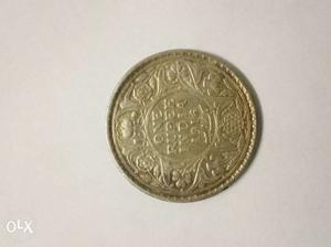 This is  coin and is of silver (George V