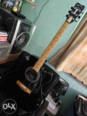 Black And Beige Acoustic Guitar