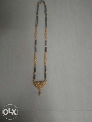 Black And Gold-colored Pendant Necklace