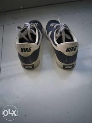 Pair Of White And Black Nike Low Top Shoes