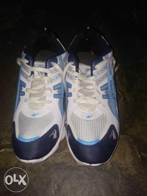 Pair Of White And Blue Basketball Shoes