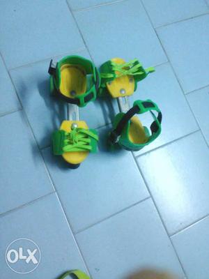 Pair Of Yellow And Green Roller Blades