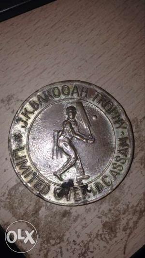 Round Silver-colored J.K Barooah Trophy Coin