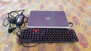 Blue Dell Laptop And Black Computer Keyboard.