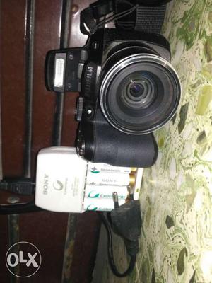 Fujifilm point and shoot Camera And White Sony Charger