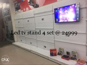 White Wooden TV Rack With Black Flat Screen TV