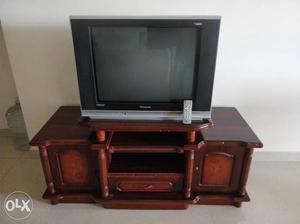 Black CRT Television And Brown Wooden TV Stand
