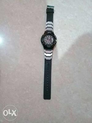 Black Round Face With Black And Grey Strap Watch