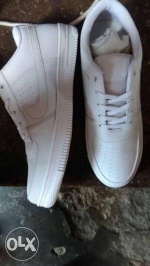Pair Of White Nike Sneakers