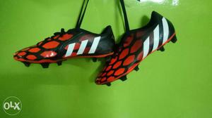Black-and-red Adidas Cleats
