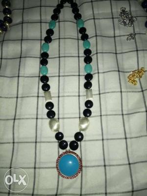Blue, White, And Black Beaded Pendant Necklace
