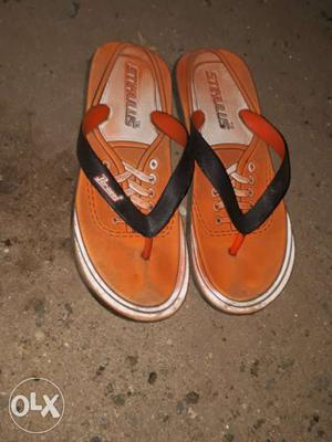 Pair Of Black-and-orange Flip Flops