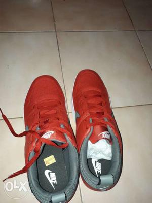 Pair Of Red Nike Low-top Shoes