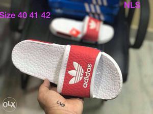 Pair Of Red-and-white Adidas Slides