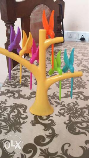 Yellow, Green, Purple, And Pink Plastic Toy Birds With Tree