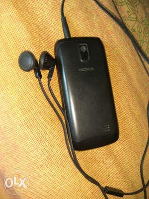 Black Nokia Candybar Phone With Black Earphones
