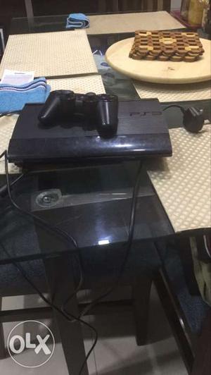 Black Sony PS3 Game Console And Game Controller