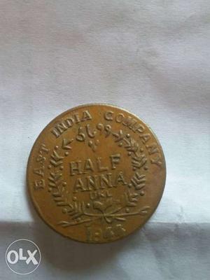 An old () coin of half anna.