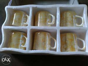 Six White-and-beige Ceramic Mugs