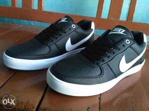 Pair Of Black And White Nike Low Top Sneakers
