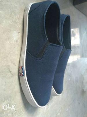 Pair Of Blue And White Slip On Shoes