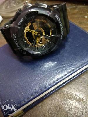 Round Black And Gold-colored Casio G-shock Watch
