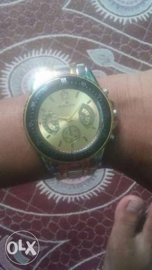 Round Gold And Black Chronograph Watch With Silver Link