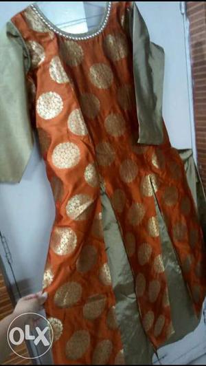 Silk look orange and golden Indo Western gown,