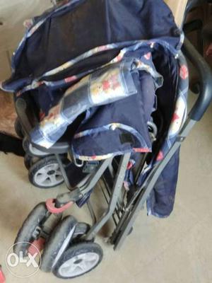 Baby's Blue And White Folding Stroller